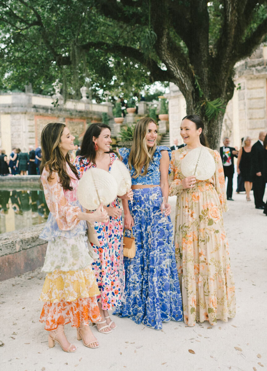 Guests enjoy an alfresco cocktail hour during a glam, garden wedding.