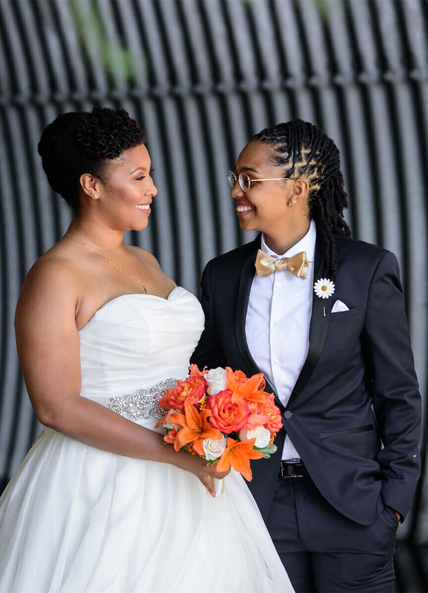 Wedding Tips: Two newlyweds smiling at each other.
