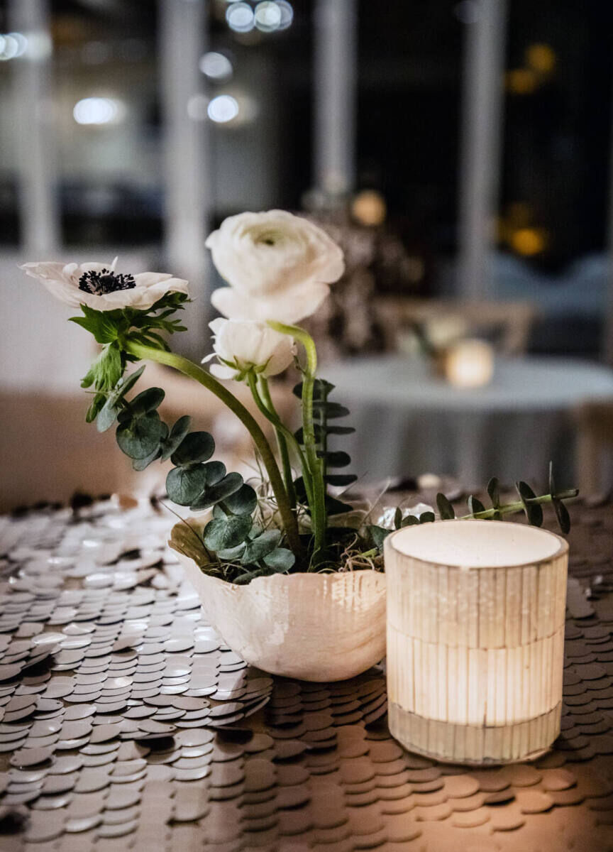 Wedding Tips: A small bouquet centerpiece next to a candle.