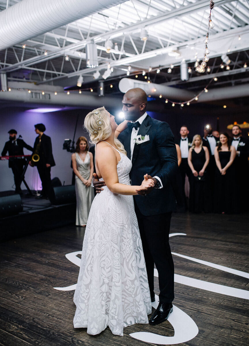 Wedding Tips: A bride and groom slow dancing in the middle of the dance floor while guests watch from the background.